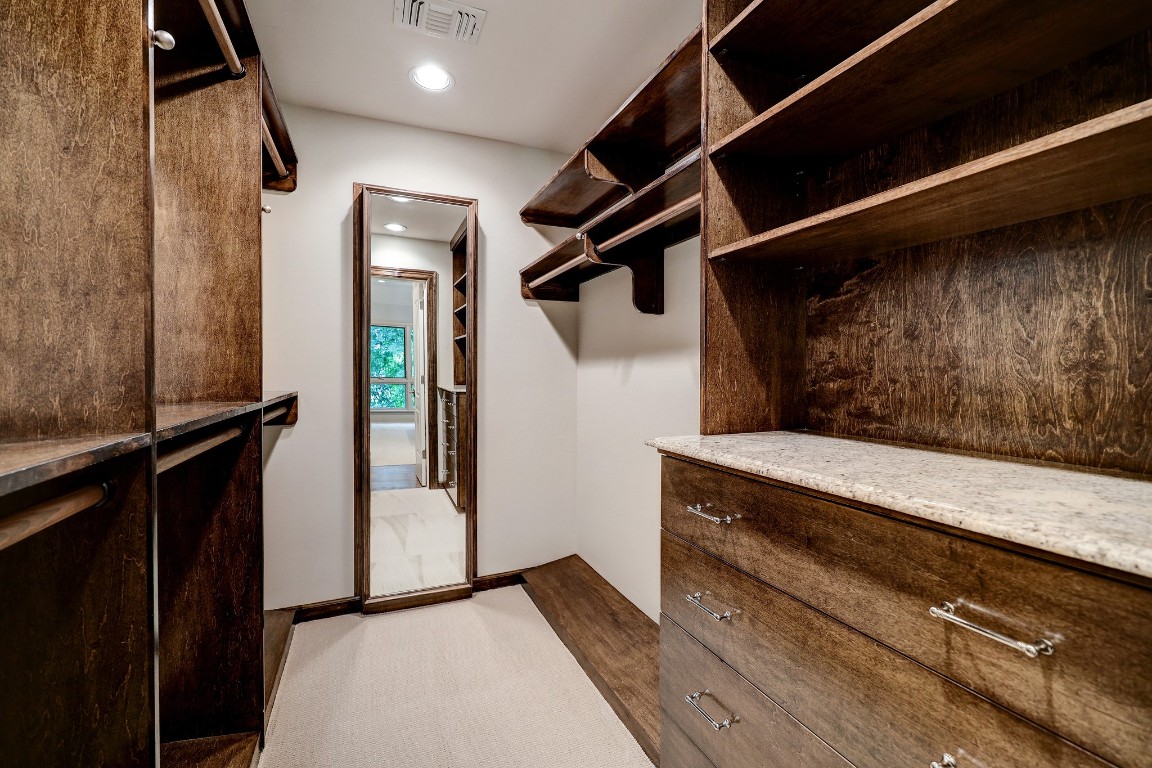 6599 Bayou Glen Road Houston, TX 77057 - Photo 31 of 41 His closet is uniquely handsome with stained walnut cabinetry featuring a built-in cabinet with full length mirror, custom hanging rods and chest of drawers. Also featured is new carpeting and recessed lighting.
