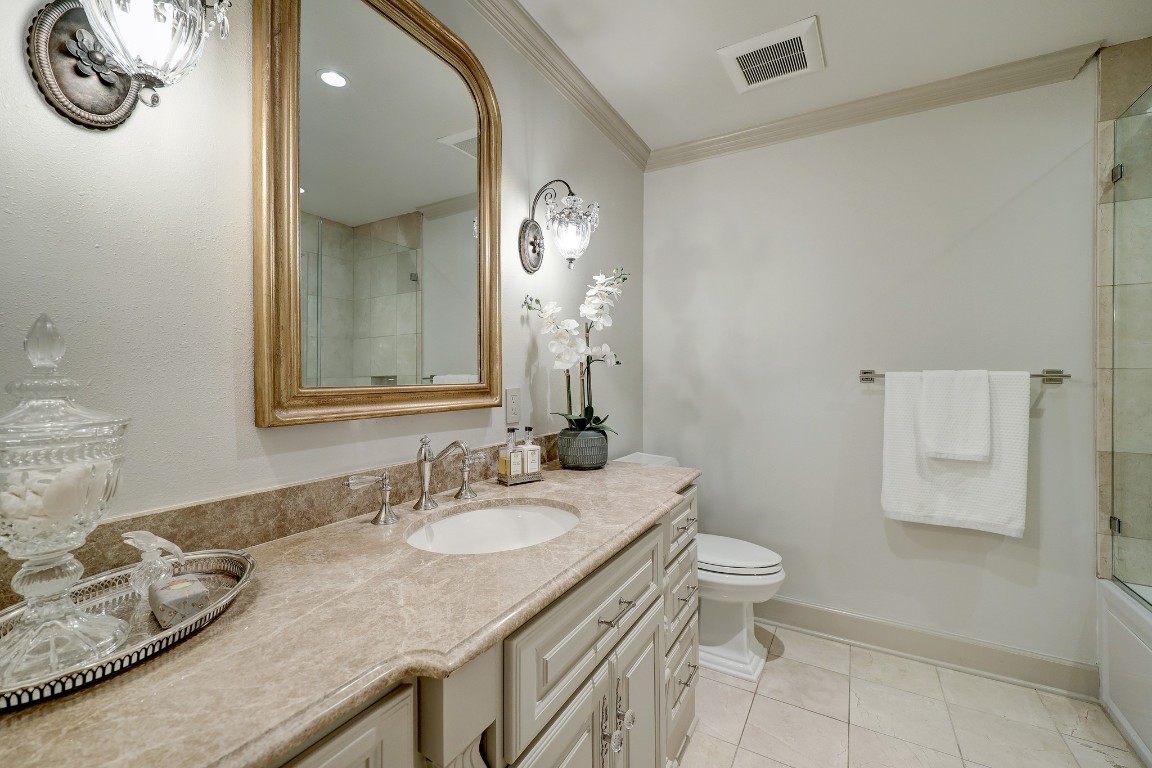 6599 Bayou Glen Road Houston, TX 77057 - Photo 33 of 41 Secondary bath is also spacious and beautifully appointed. Long slab marble counters, beautiful custom vanity, antique french gold mirror and decorative wall sconces.