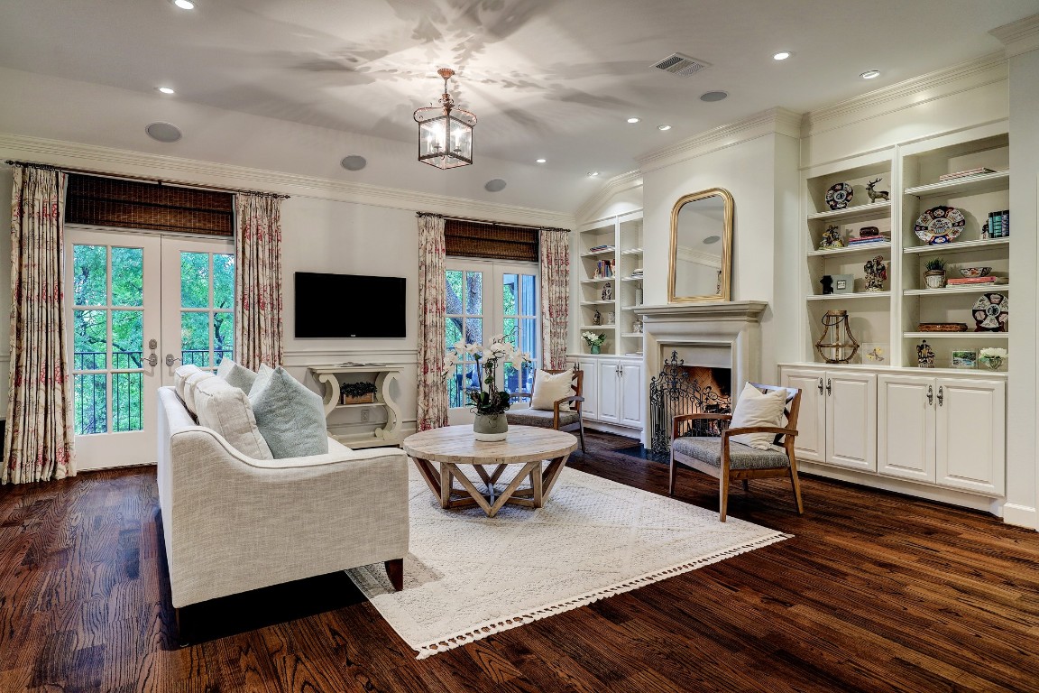 6599 Bayou Glen Road Houston, TX 77057 - Photo 5 of 41 The living room is stunning featuring soaring 11' ceilings, surround sound, french doors leading to a large balcony with incredible views and gorgeous hardwood floors.