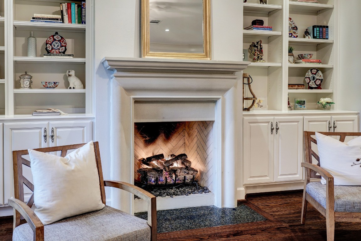 6599 Bayou Glen Road Houston, TX 77057 - Photo 6 of 41 The fireplace turns on with easy remote. It's stunning with the stone surround and flanked by the custom bookcases.