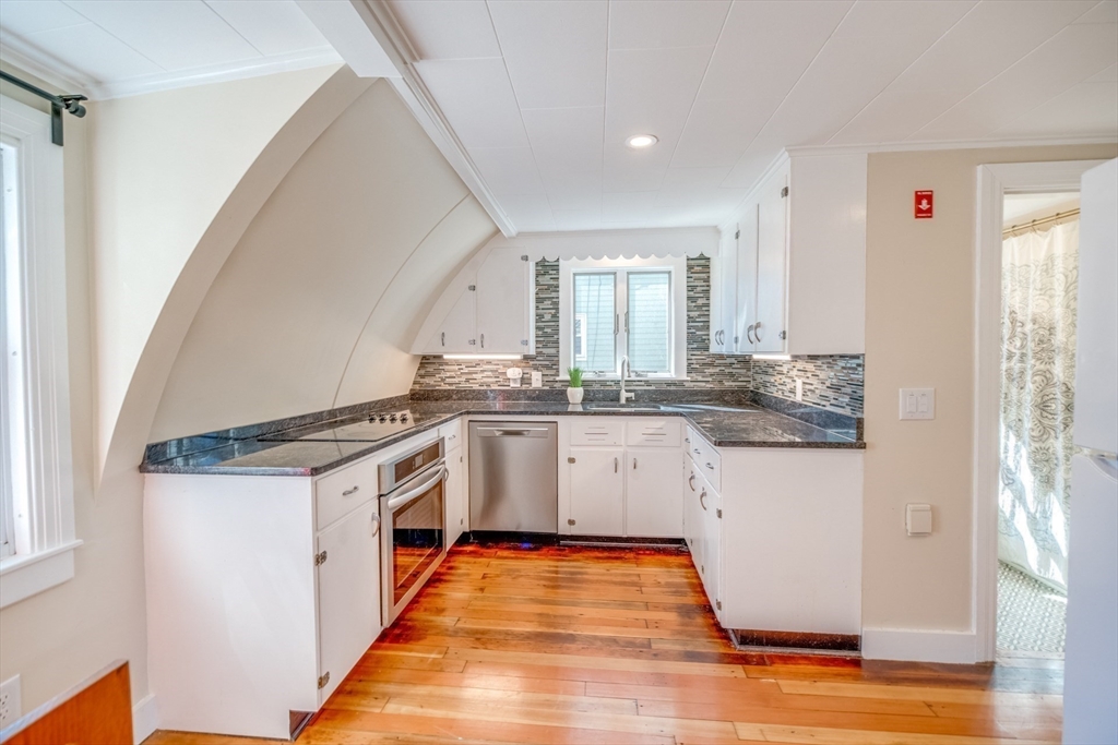 27 Bryan Avenue Easthampton, MA 01027 - Photo 15 of 39 a kitchen with granite countertop white cabinets and white appliances