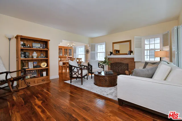 a living room with furniture a rug and a fireplace