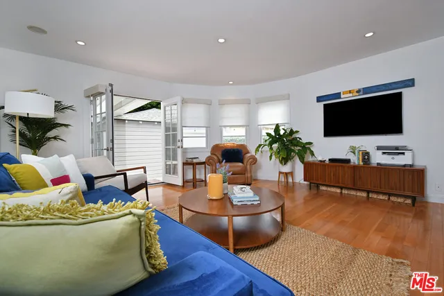 a kitchen with stainless steel appliances a refrigerator stove and wooden floor