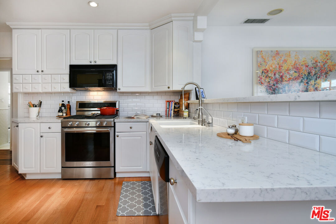 4226 Greenbush Avenue Sherman Oaks, CA 91423 - Photo 29 of 69 a kitchen with stainless steel appliances a stove microwave and sink