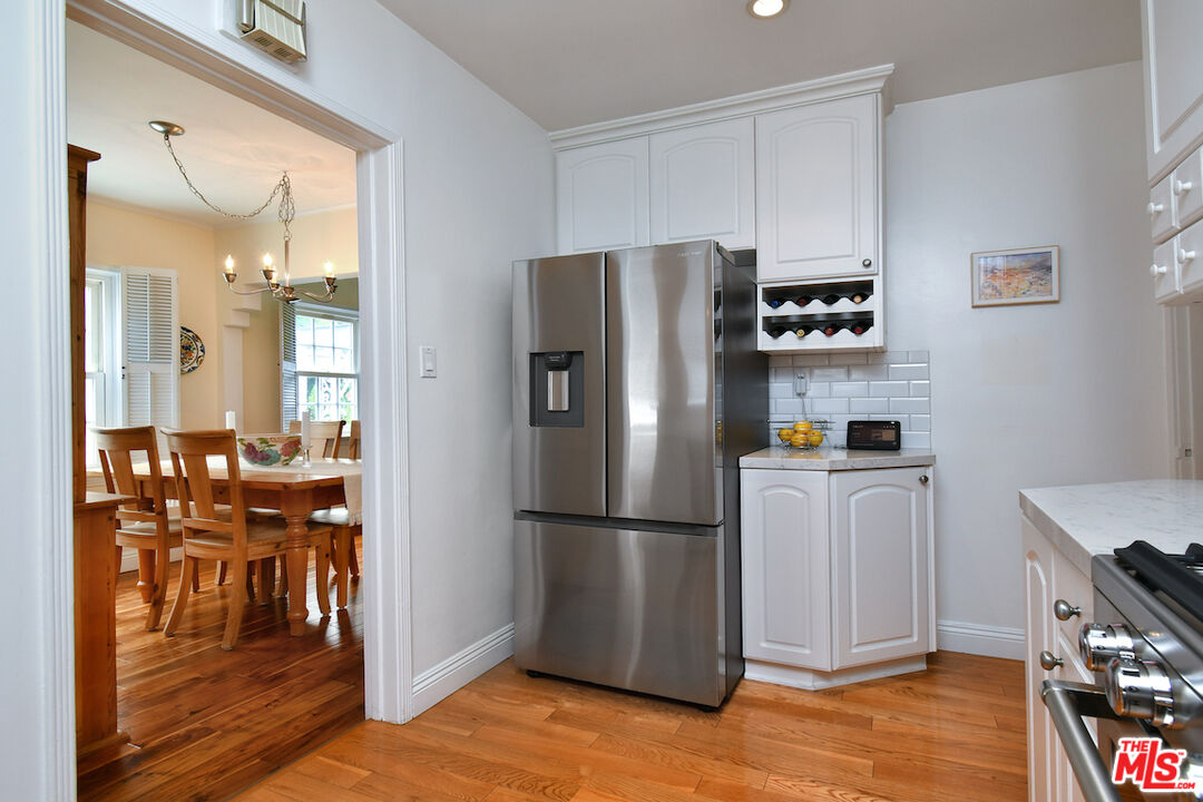 4226 Greenbush Avenue Sherman Oaks, CA 91423 - Photo 32 of 69 a kitchen with stainless steel appliances a refrigerator stove and wooden floor