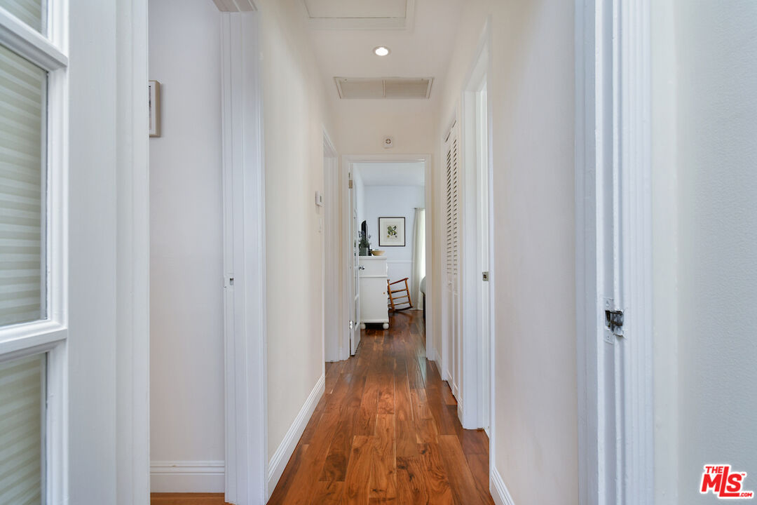 4226 Greenbush Avenue Sherman Oaks, CA 91423 - Photo 34 of 69 a view of a hallway with wooden floor and a bathroom