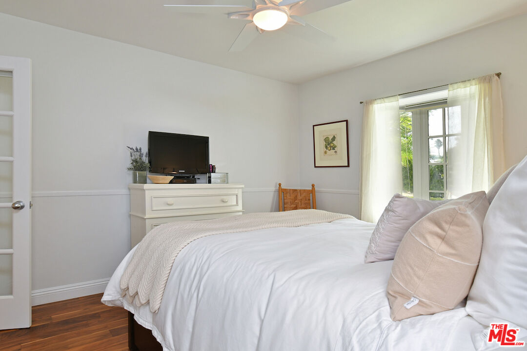 4226 Greenbush Avenue Sherman Oaks, CA 91423 - Photo 37 of 69 a bedroom with a bed and a flat screen tv