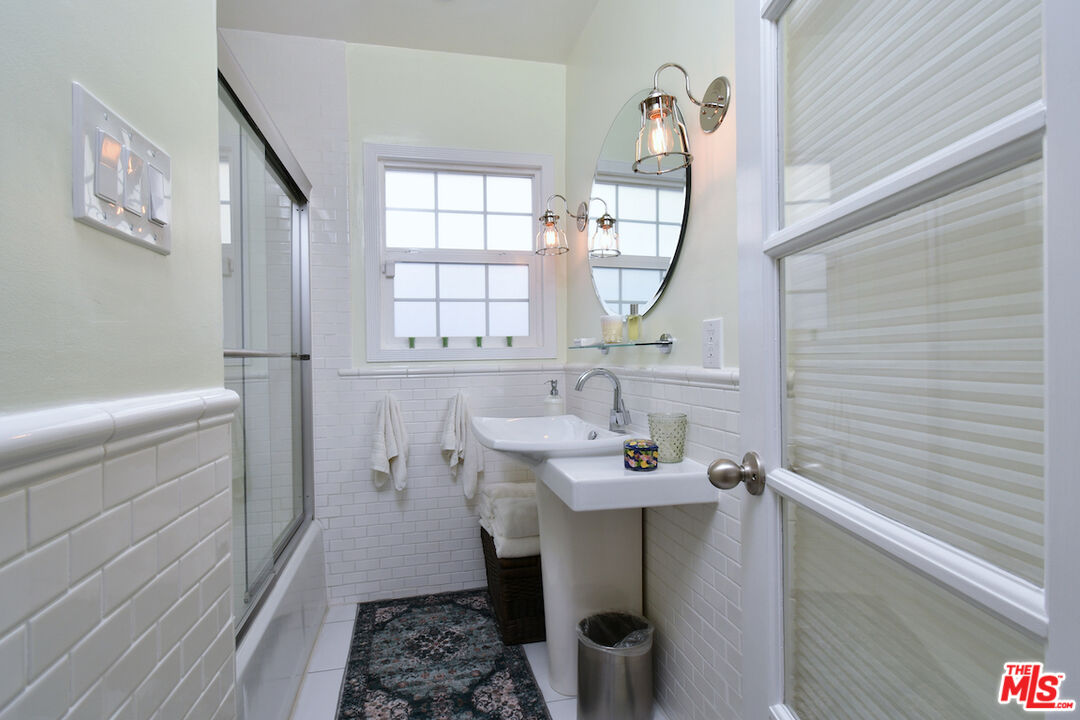 4226 Greenbush Avenue Sherman Oaks, CA 91423 - Photo 41 of 69 a bathroom with a sink a mirror and a window