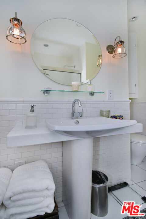 4226 Greenbush Avenue Sherman Oaks, CA 91423 - Photo 43 of 69 a bathroom with a sink and a mirror