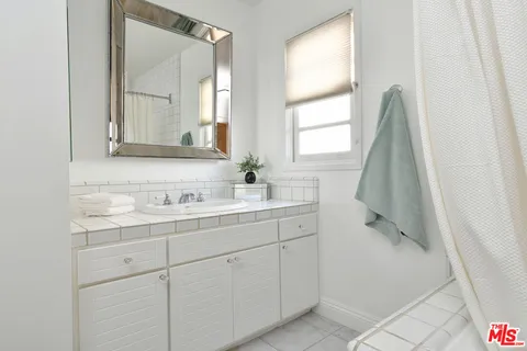 a view of a patio with dining table and chairs with wooden floor and fence
