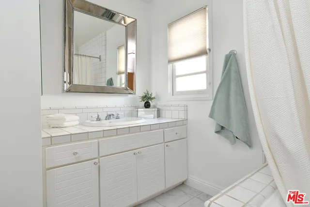 a view of a patio with dining table and chairs with wooden floor and fence