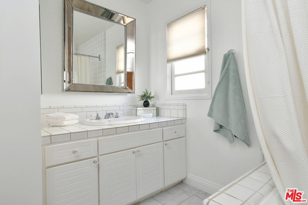 4226 Greenbush Avenue Sherman Oaks, CA 91423 - Photo 47 of 69 a bathroom with a sink and a mirror