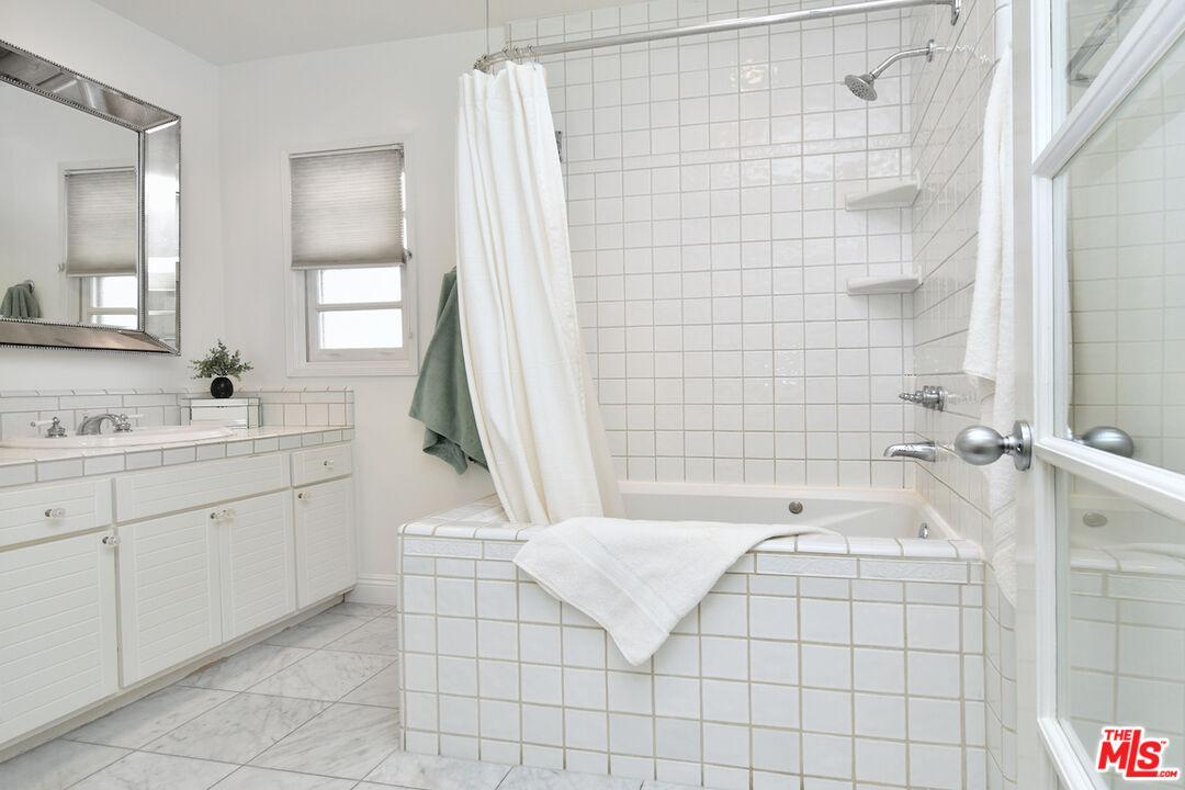 4226 Greenbush Avenue Sherman Oaks, CA 91423 - Photo 48 of 69 a spacious bathroom with a bathtub and sink