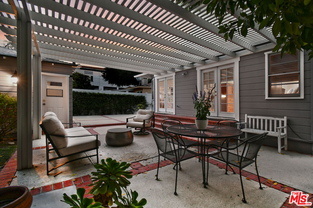 4226 Greenbush Avenue Sherman Oaks, CA 91423 - Photo 66 of 69 a view of a patio with dining table and chairs with wooden floor and fence