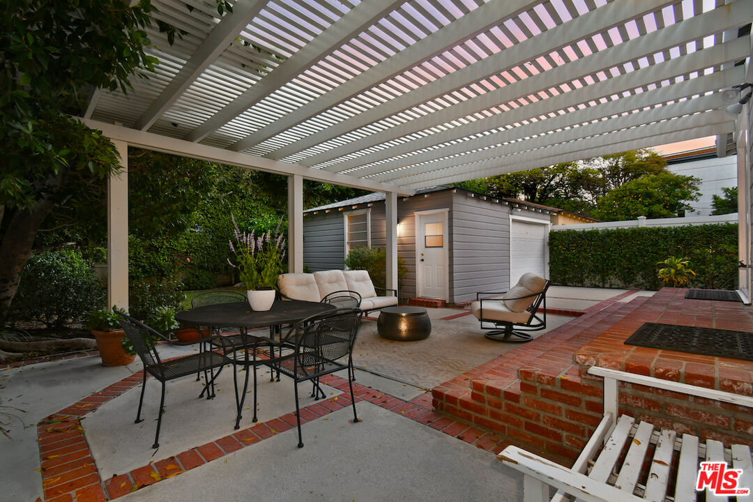 4226 Greenbush Avenue Sherman Oaks, CA 91423 - Photo 68 of 69 a view of a patio with table and chairs with wooden floor and fence