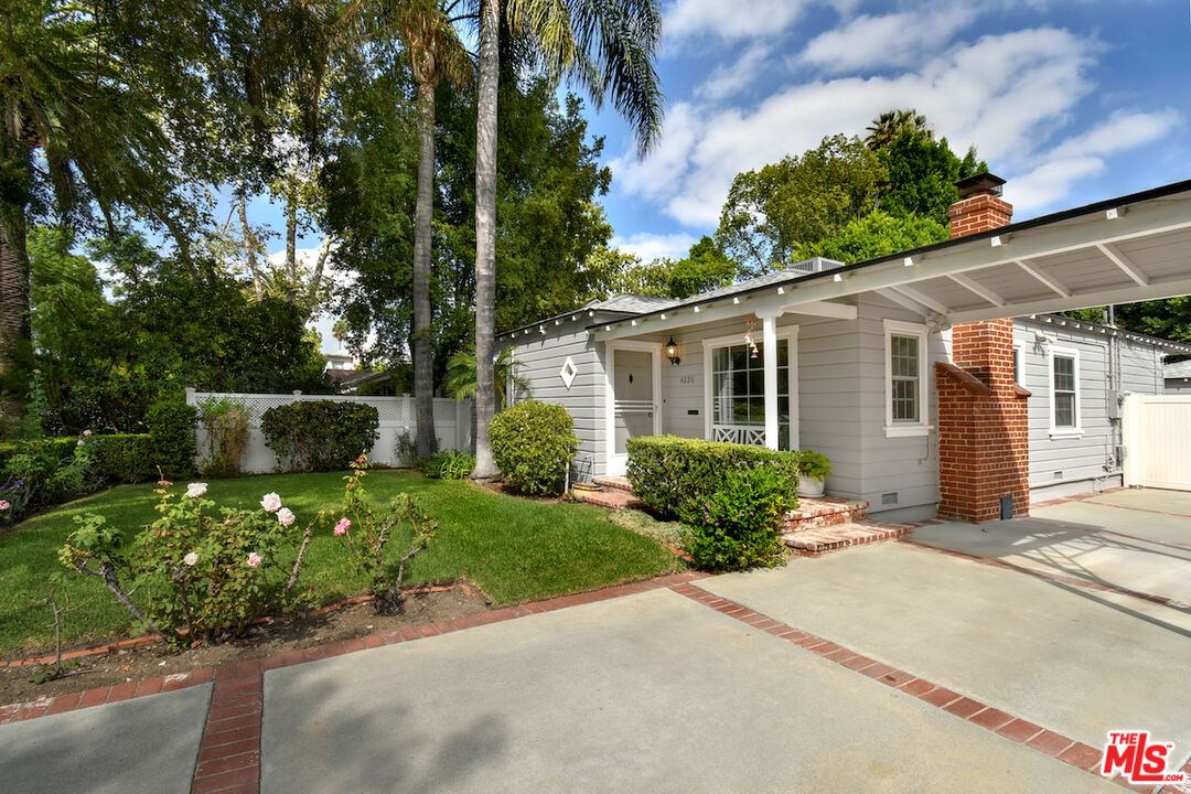 4226 Greenbush Avenue Sherman Oaks, CA 91423 - Photo 8 of 69 a front view of a house with a yard and potted plants
