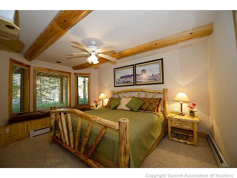 311 Red Hawk Circle Silverthorne, CO 80498 - Photo 14 of 25 a bedroom with a bed and a large window