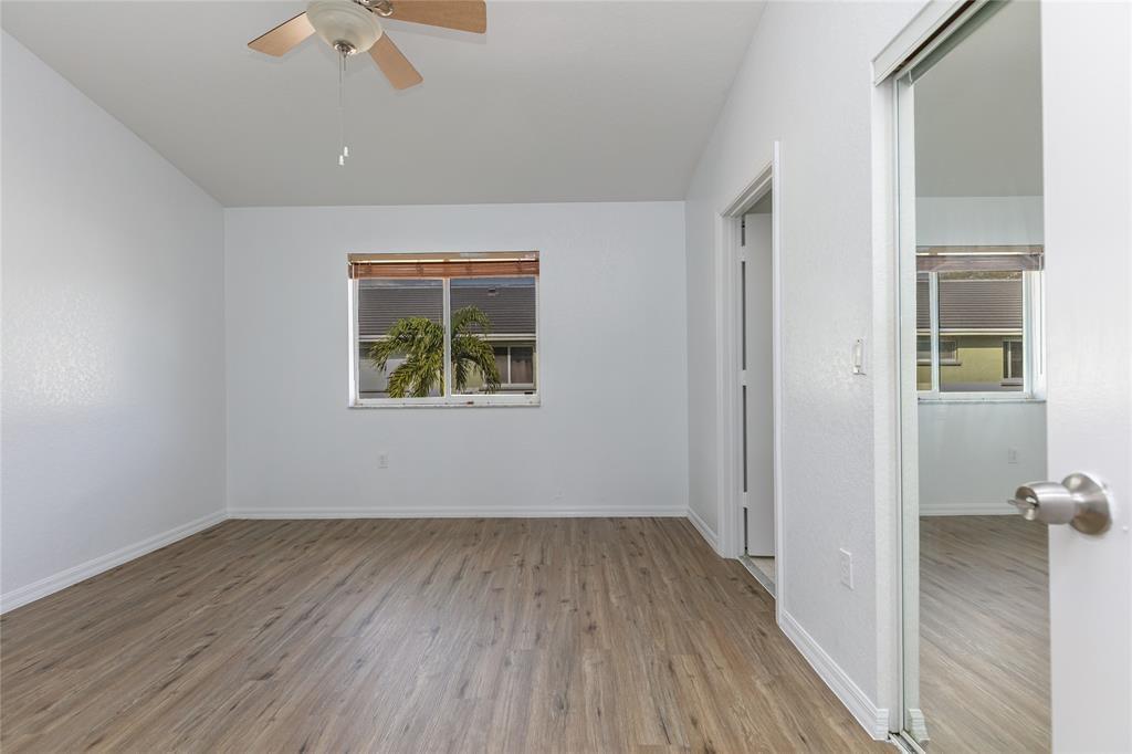 159 Hidden Ct Road, Unit I49 Hollywood, FL 33023 - Photo 14 of 21 an empty room with wooden floor and windows