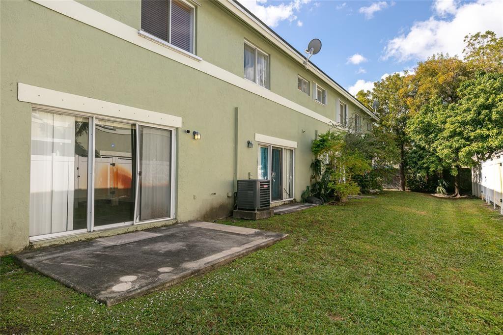 159 Hidden Ct Road, Unit I49 Hollywood, FL 33023 - Photo 20 of 21 a view of a house with backyard porch and garden
