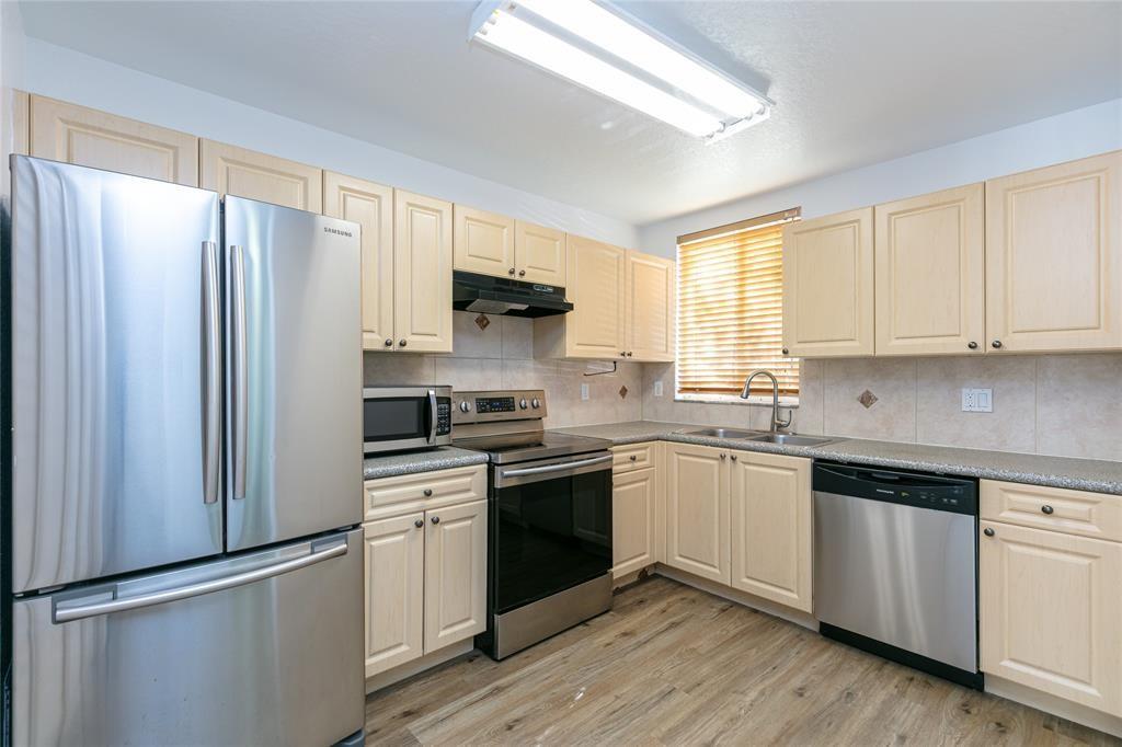 159 Hidden Ct Road, Unit I49 Hollywood, FL 33023 - Photo 4 of 21 a kitchen with stainless steel appliances a sink cabinets and a window