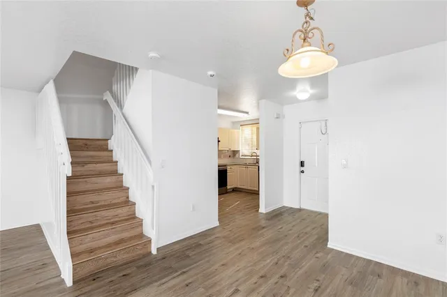 a view of a hallway with wooden floor and entryway
