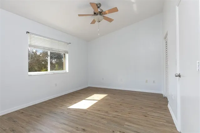 wooden floor in an empty room with a window