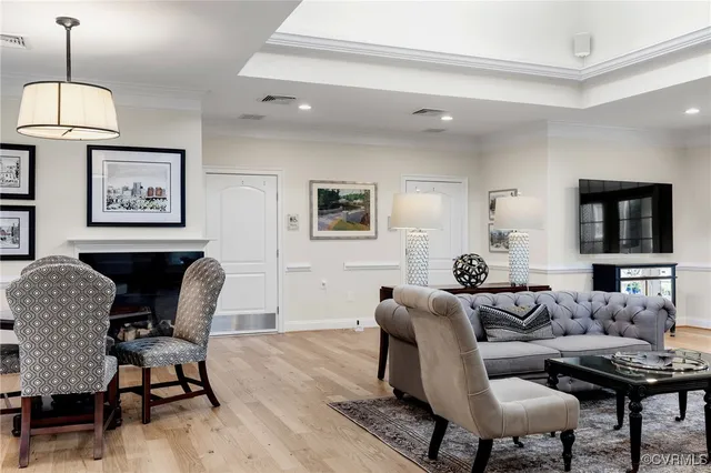 a living room with furniture and wooden floor