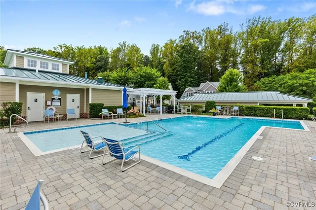 a view of a house with swimming pool and sitting area