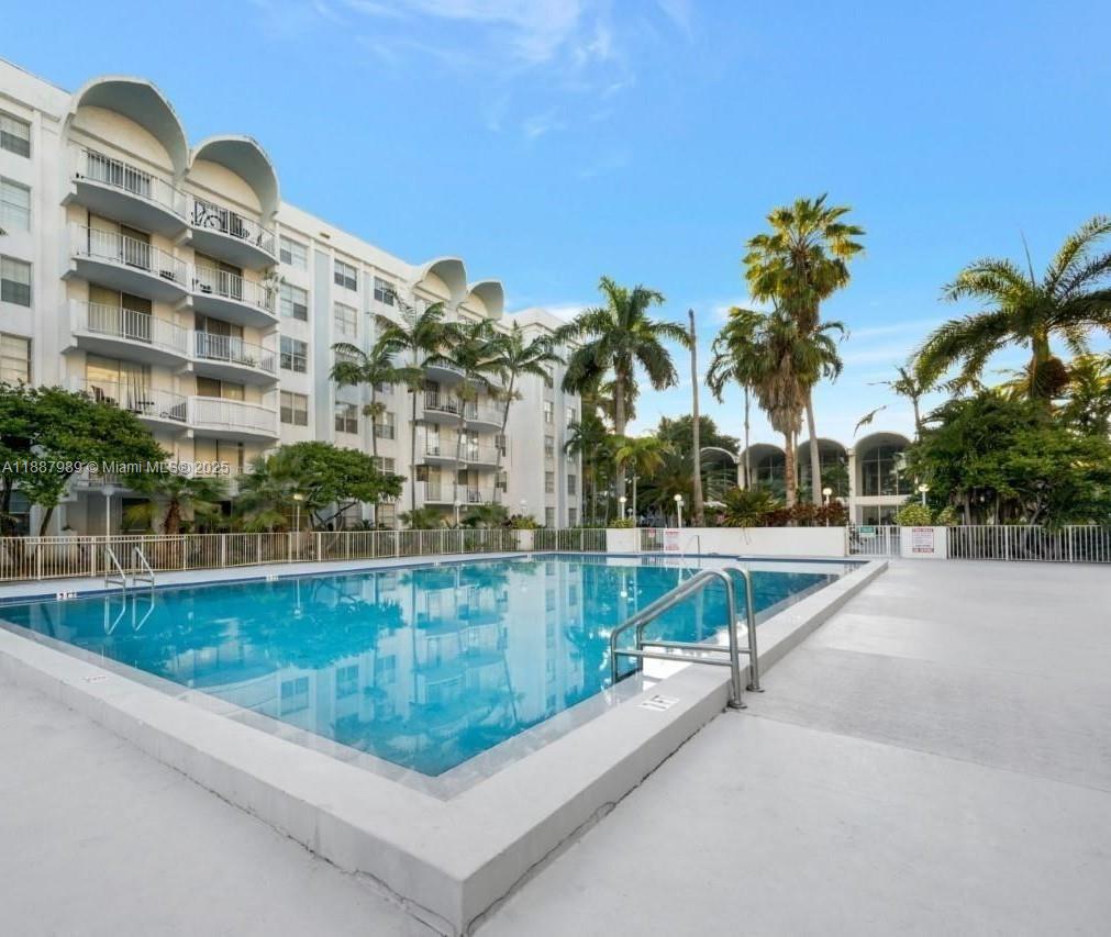 498 Northwest 165th Street, Unit D405 Miami, FL 33169 - Photo 11 of 12 a view of swimming pool from a balcony