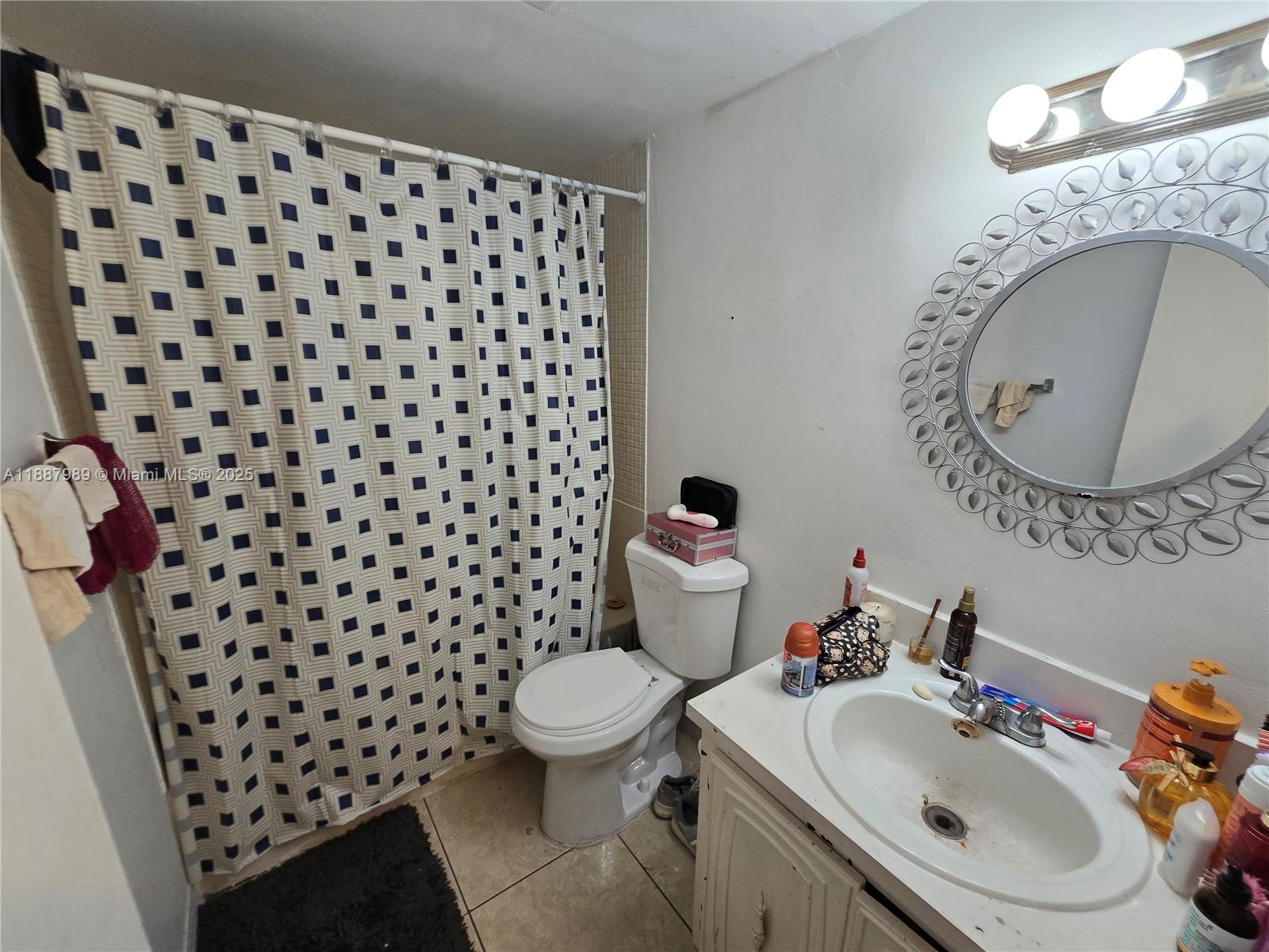 498 Northwest 165th Street, Unit D405 Miami, FL 33169 - Photo 6 of 12 a bathroom with a sink and a mirror