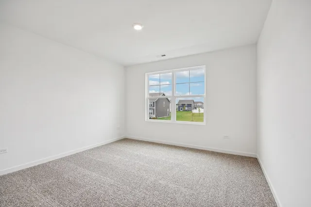 a view of a hallway with white walls and wooden floor