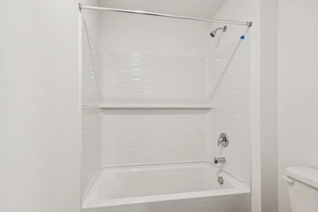 a living room with furniture and a painting on the wall