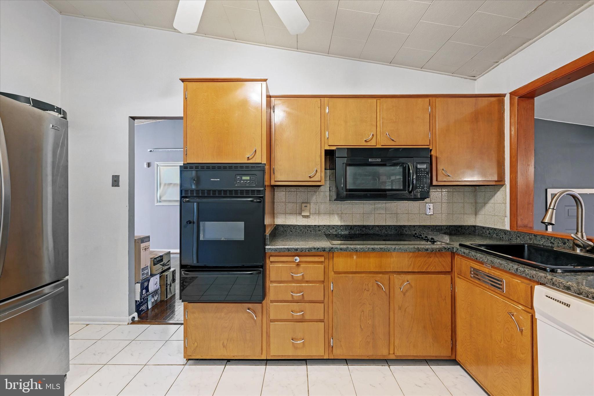 3714 Parkfield Road Windsor Mill, MD 21244 - Photo 11 of 28 a kitchen with stainless steel appliances a stove microwave and refrigerator