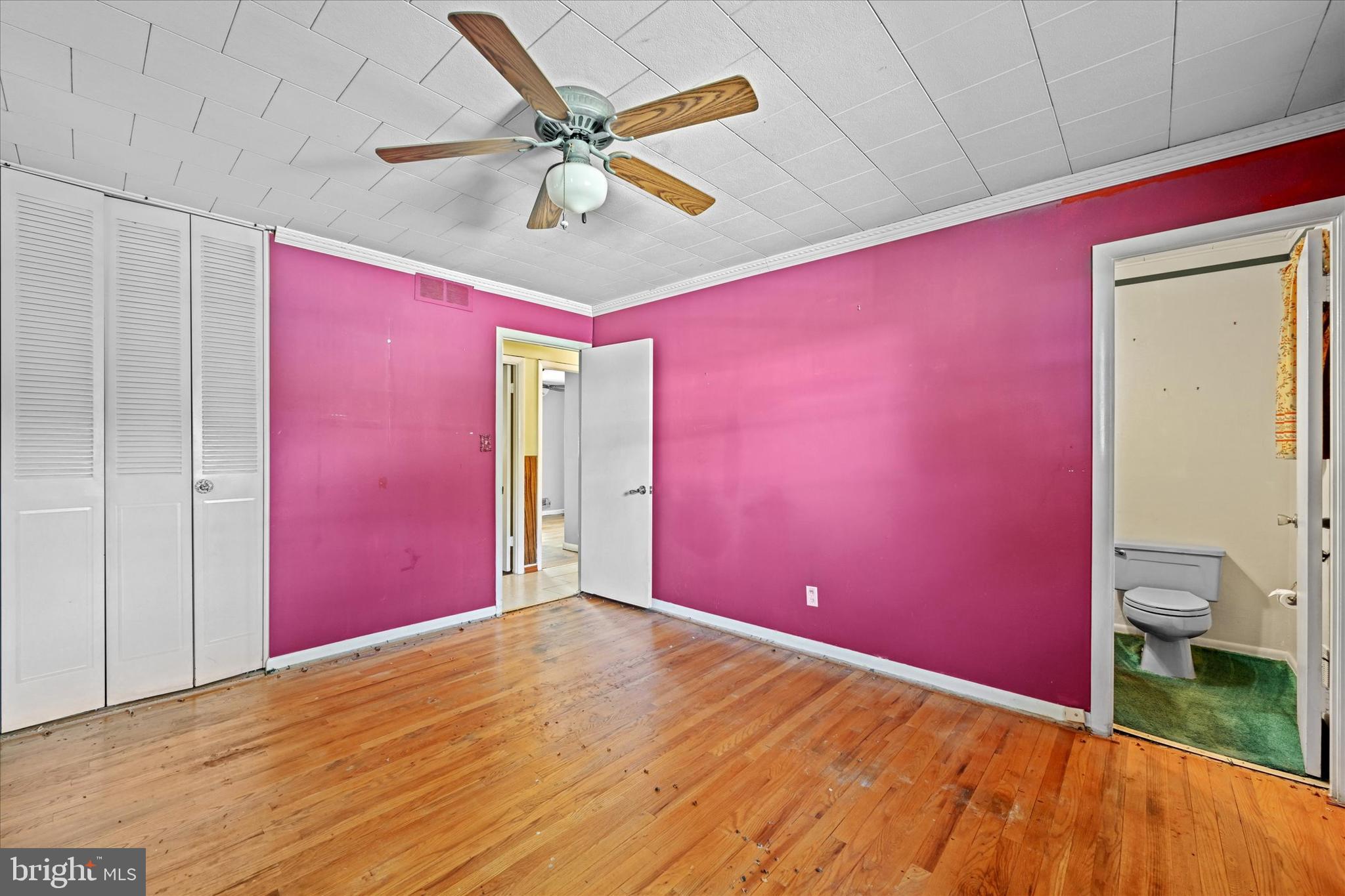 3714 Parkfield Road Windsor Mill, MD 21244 - Photo 17 of 28 a view of a big room with wooden floor and a ceiling fan