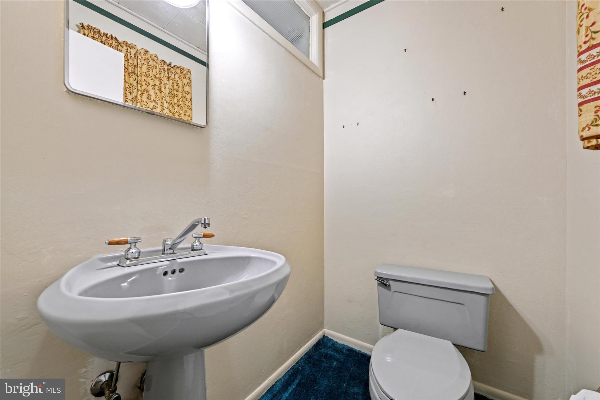 3714 Parkfield Road Windsor Mill, MD 21244 - Photo 18 of 28 a bathroom with a sink mirror and toilet