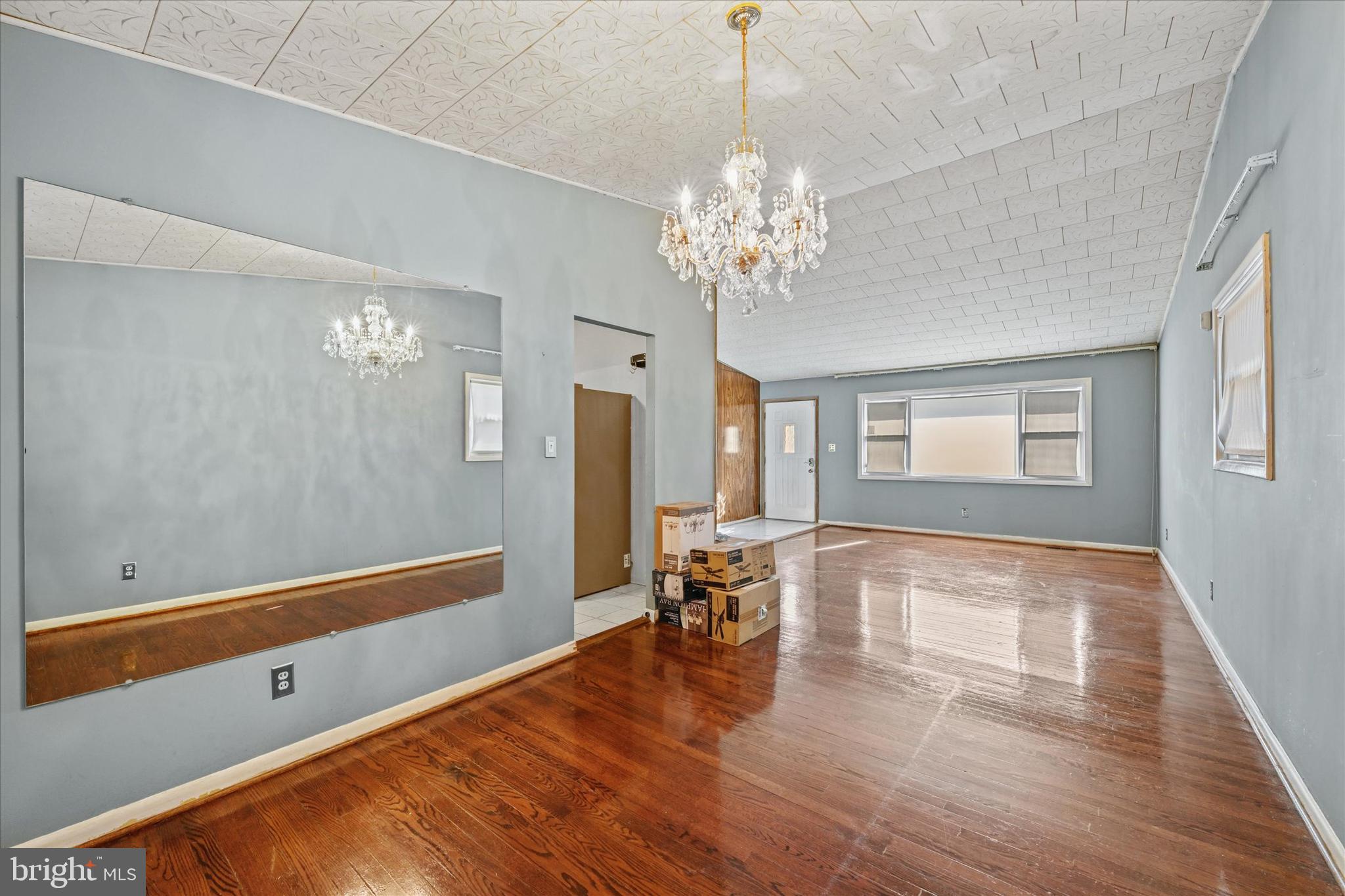 3714 Parkfield Road Windsor Mill, MD 21244 - Photo 8 of 28 a view of a room with wooden floor and chandelier