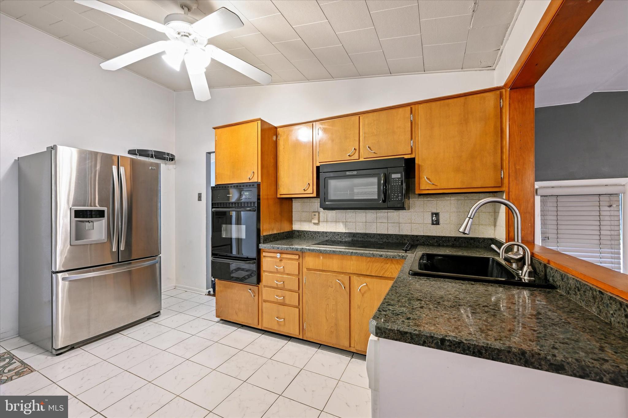 3714 Parkfield Road Windsor Mill, MD 21244 - Photo 10 of 28 a kitchen with stainless steel appliances granite countertop a refrigerator a oven a sink and dishwasher
