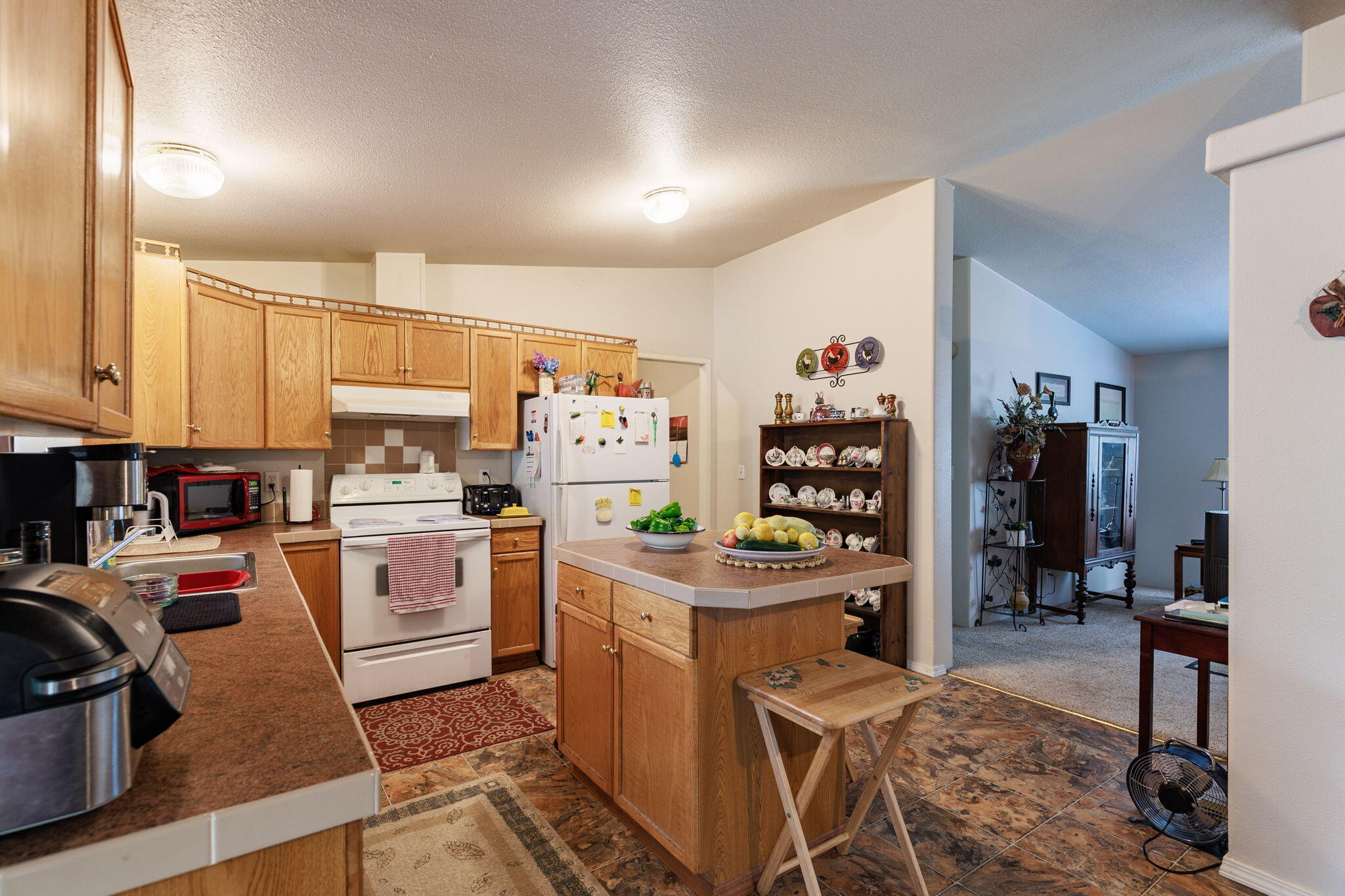 2040 Robertson Bridge Road Grants Pass, OR 97526 - Photo 5 of 39 a view of a kitchen with fridge and workspace