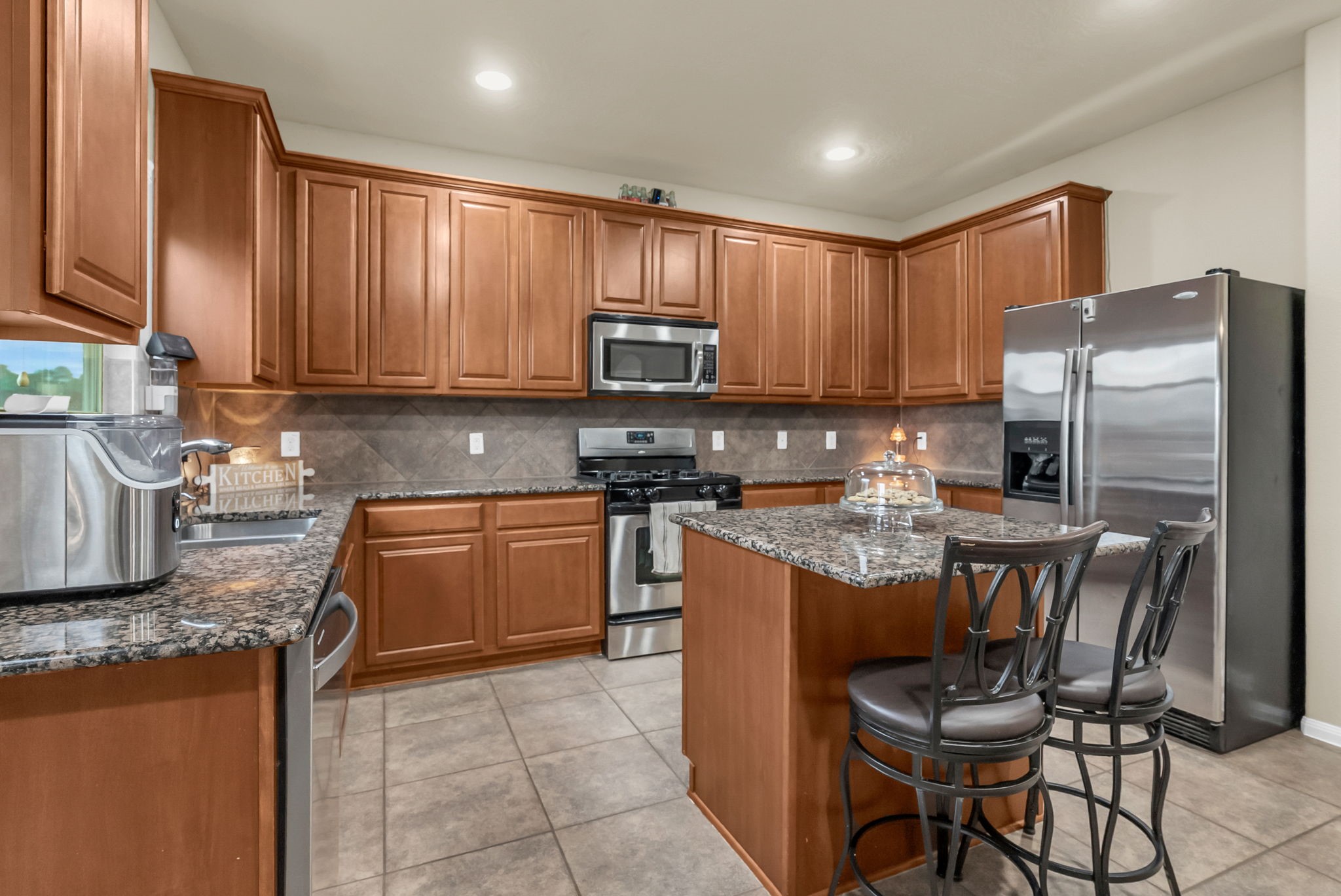 16619 Dover Mills Drive Spring, TX 77379 - Photo 17 of 49 a kitchen with stainless steel appliances granite countertop a stove refrigerator sink and cabinets