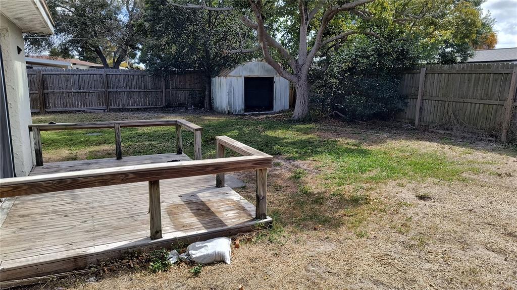 3910 Darlington Road Holiday, FL 34691 - Photo 11 of 11 a view of a backyard with a small cabin and wooden fence