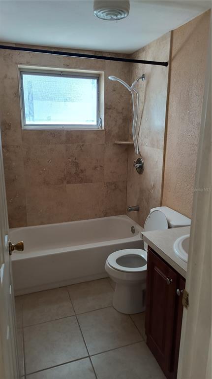 3910 Darlington Road Holiday, FL 34691 - Photo 8 of 11 a bathroom with a granite countertop toilet a sink and a bathtub