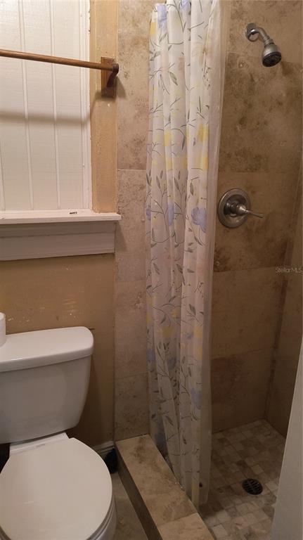 3910 Darlington Road Holiday, FL 34691 - Photo 9 of 11 a white toilet sitting next to a bathroom sink