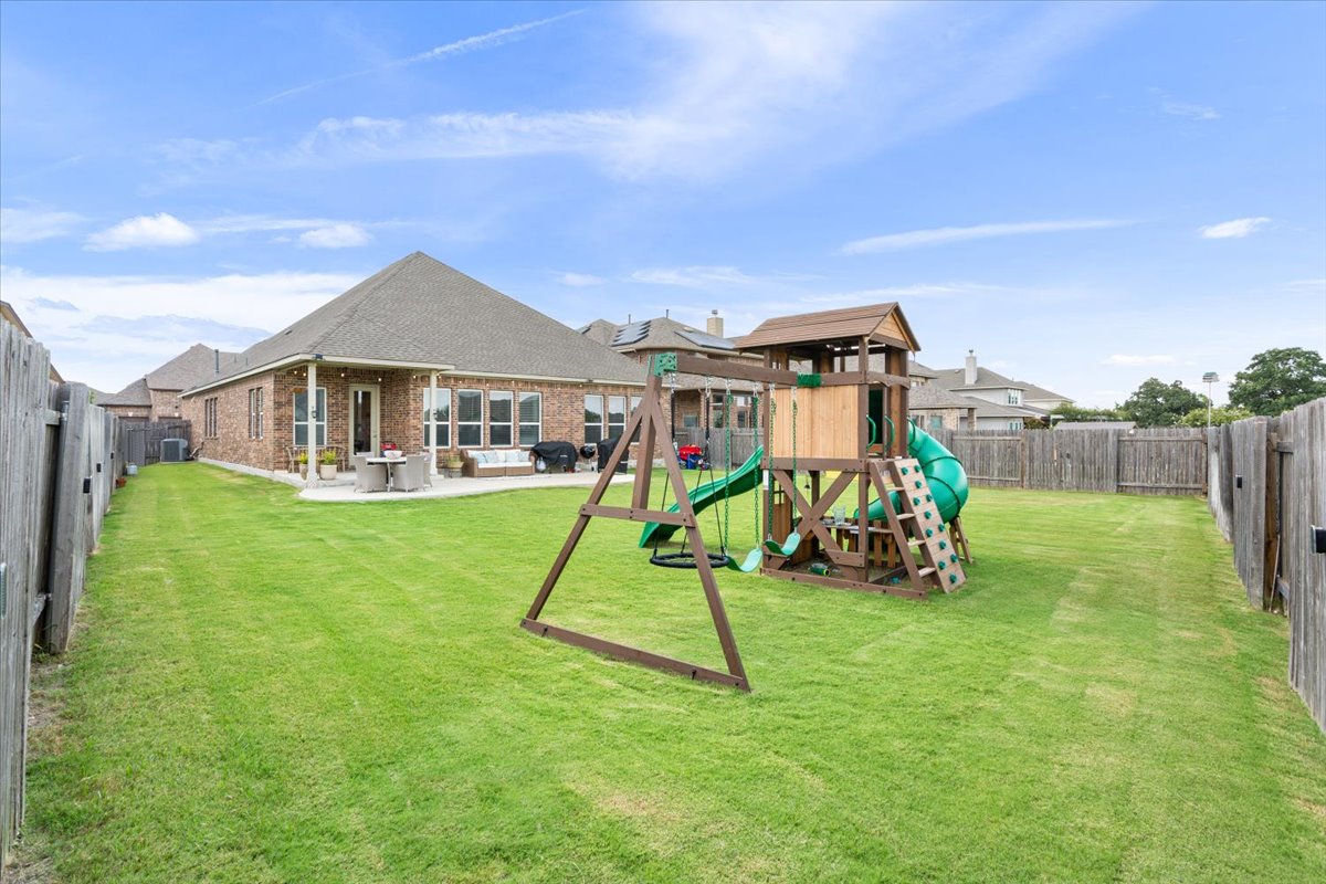 424 Millard Street Georgetown, TX 78628 - Photo 34 of 37 A spacious, well-maintained yard provides ample room for outdoor recreation and relaxation.