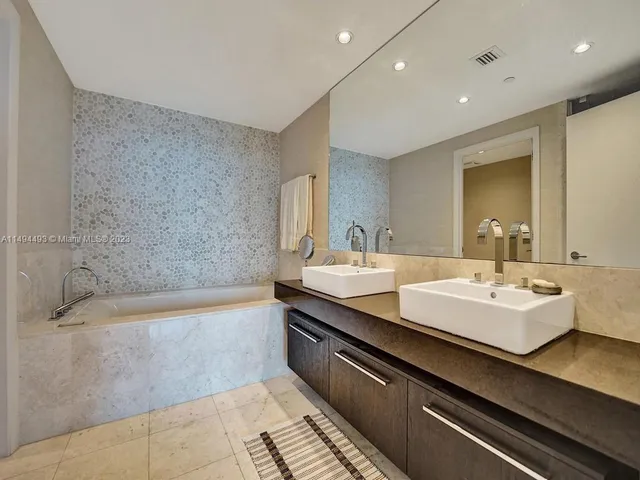 a view of a livingroom with wooden floor and a chandelier