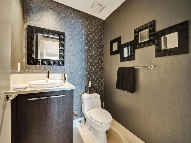 an aerial view of a house with pool table and chairs