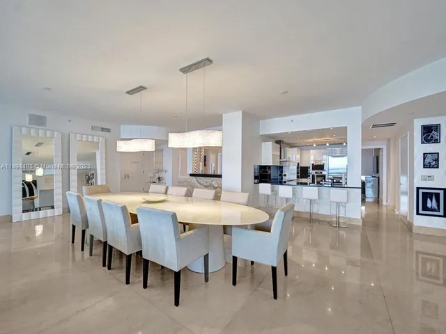 a kitchen with stainless steel appliances kitchen island granite countertop a sink a stove top oven a counter space and cabinets