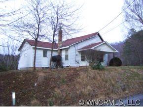 149 Howards Hollow Road Canton, NC 28716 - Photo 2 of 12 a front view of a house with a yard and garage