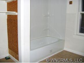 149 Howards Hollow Road Canton, NC 28716 - Photo 10 of 12 a bath tub sitting next to a window
