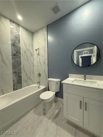 a large kitchen with a refrigerator and a stove top oven