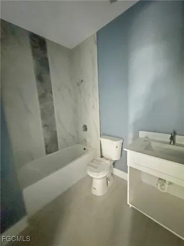 a bathroom with a toilet a sink and bathtub
